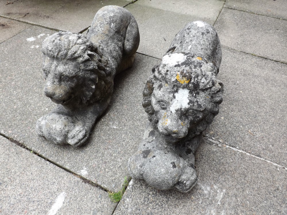 pair of early c20th composition 'stone' italianate crouching lions