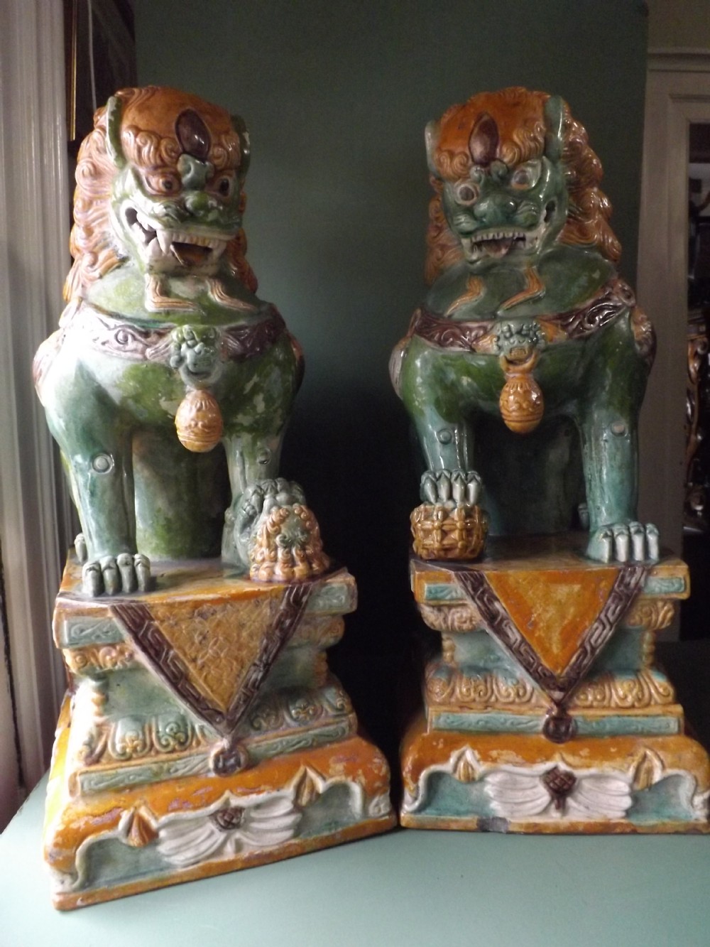 pair of early c20th chinese 'sancai'glazed terracotta buddhistic temple dogs