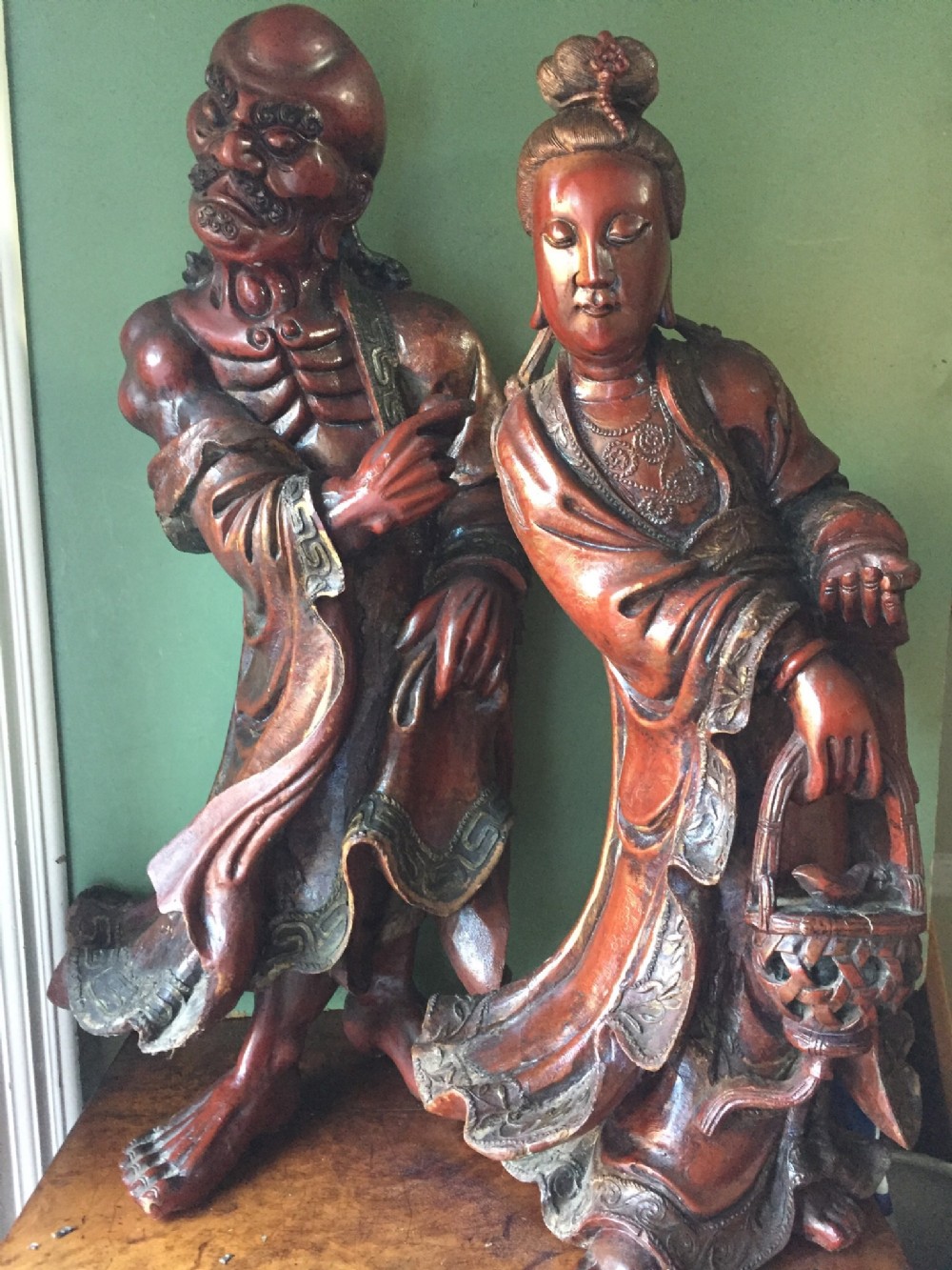 pair of large c19th japanese red lacquer decorated carved wooden figures