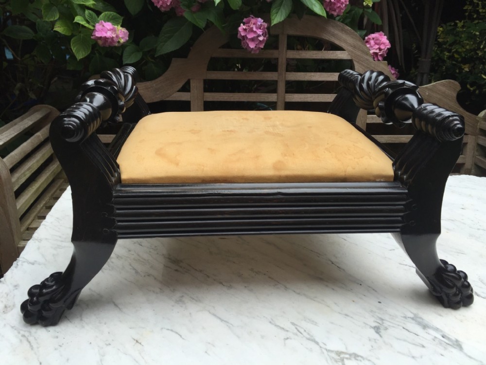 mid c19th angloindian ceylanese carved ebony footstool of scrollended form