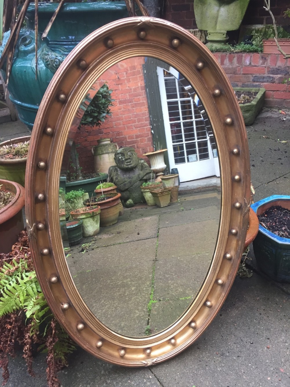 late c19th oval giltwoodframed mirror in the regency style