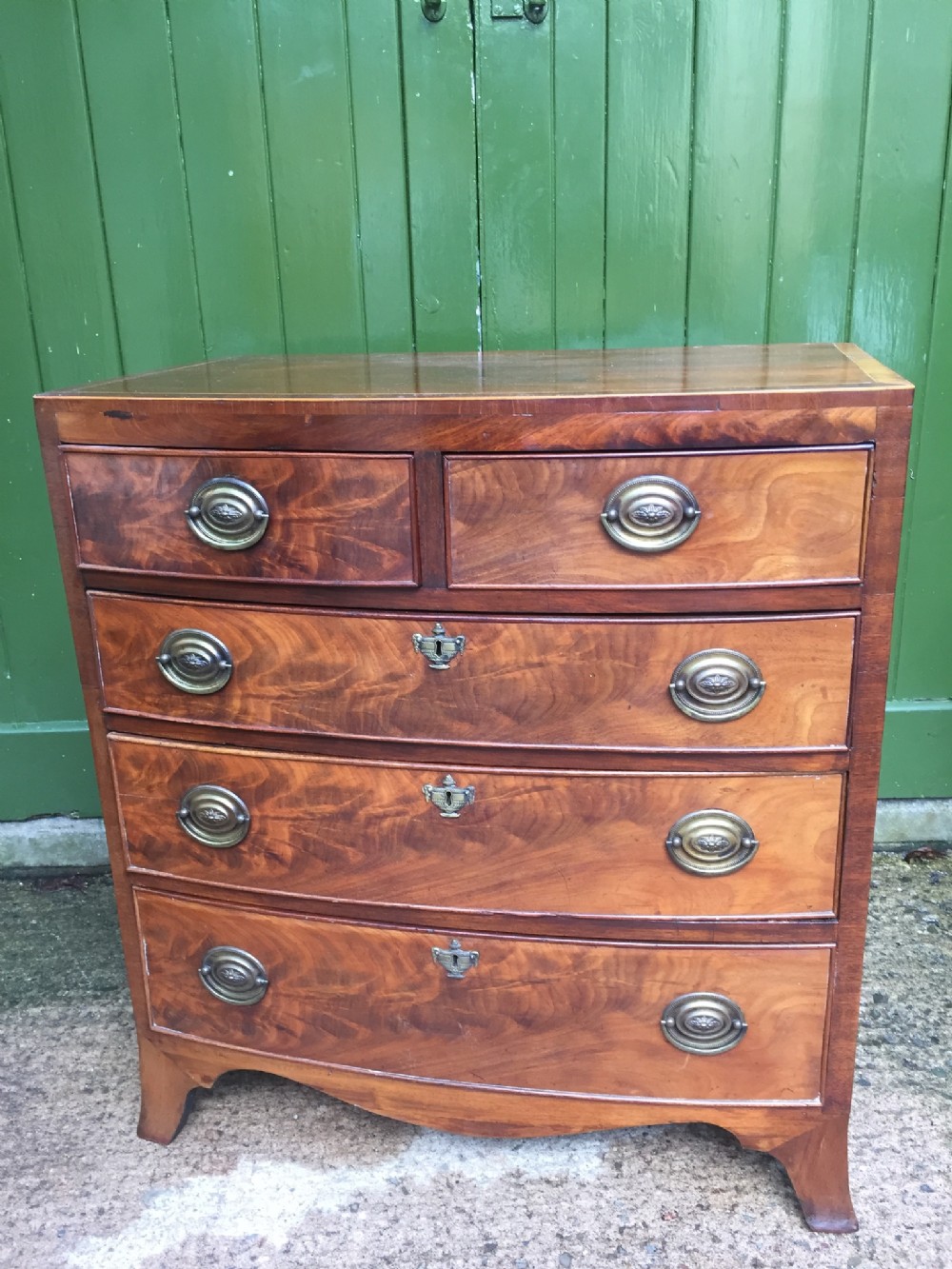 early c19th regency period bowfront mahogany chest of drawers of useful small proportions