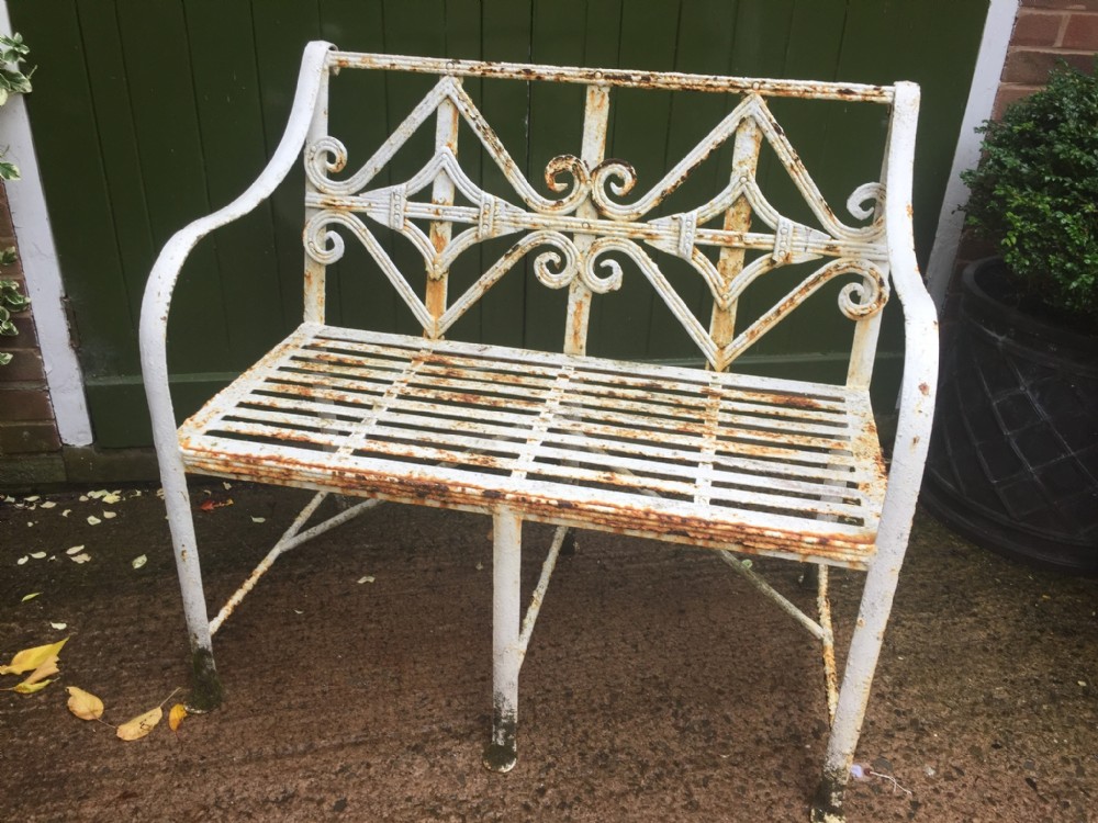 early c19th regency period wroughtiron garden seat of small proportions with intricately designed back