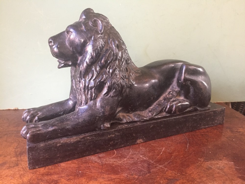 late c19th castiron model of a recumbent lion on a rectangular plinth base