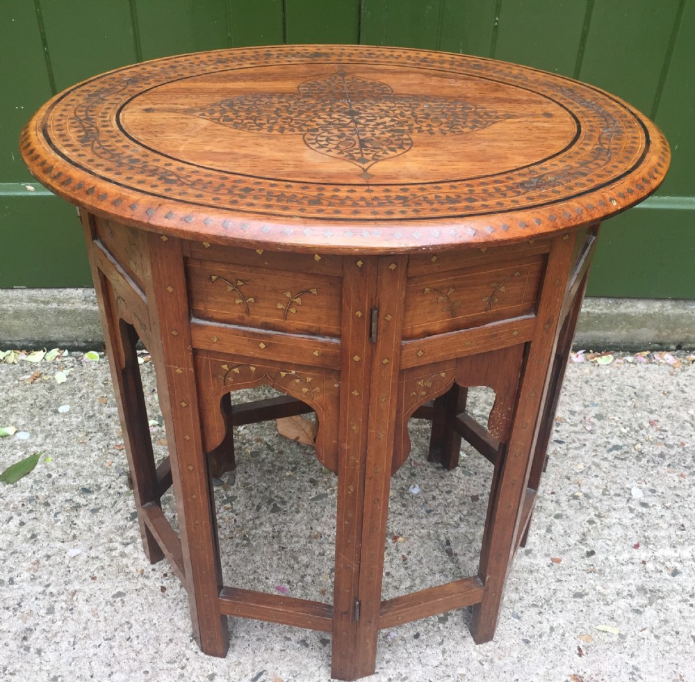 late c19th indian brassinlaid oval teak occasional table on folding arcaded base