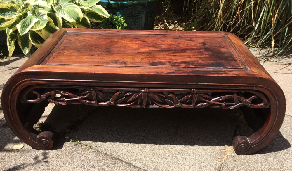 late c19th chinese qing dynasty carved hardwood 'kang' or opium table of scrollend design