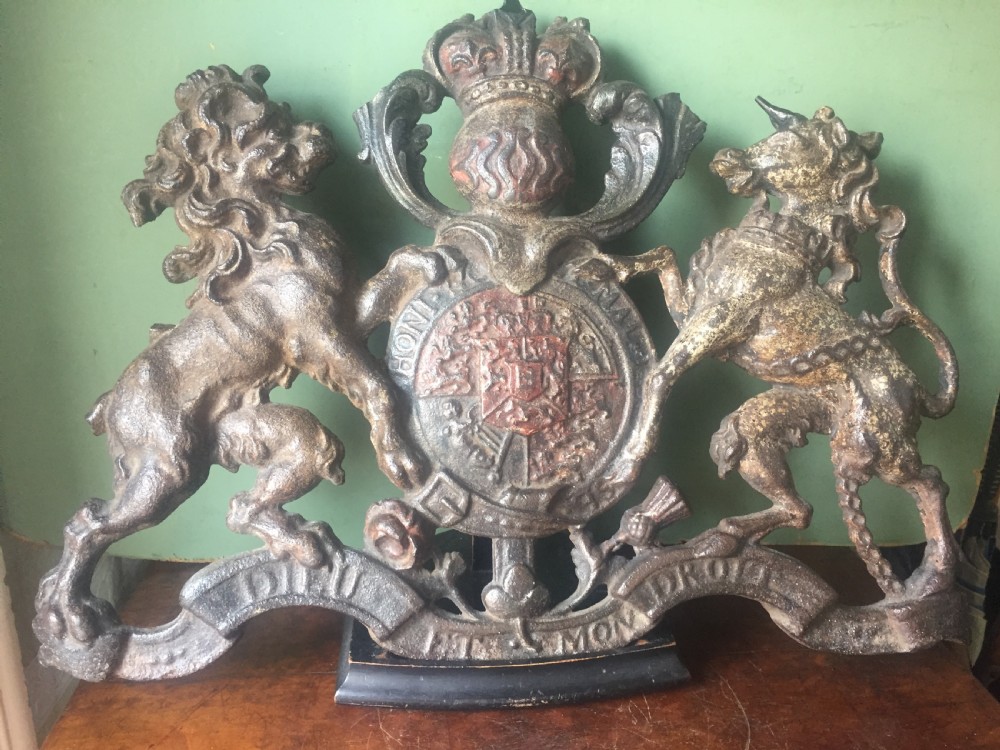 mid c19th british castiron 'coat of arms' or royal cypher with traces of original polychrome painted decoration