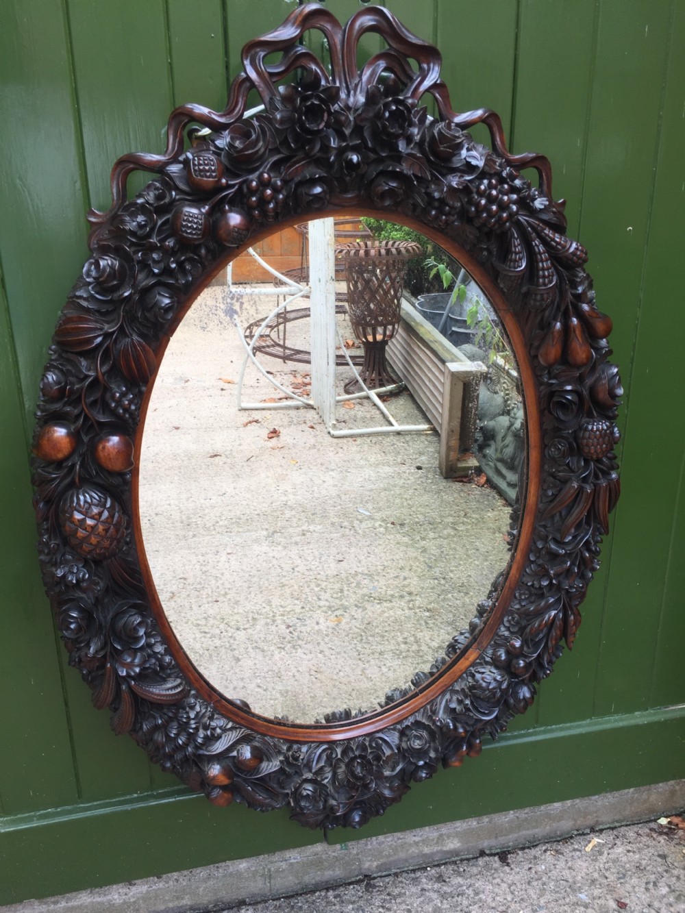exceptional mid c19th indoportuguese carved rosewood or padauk framed oval mirror