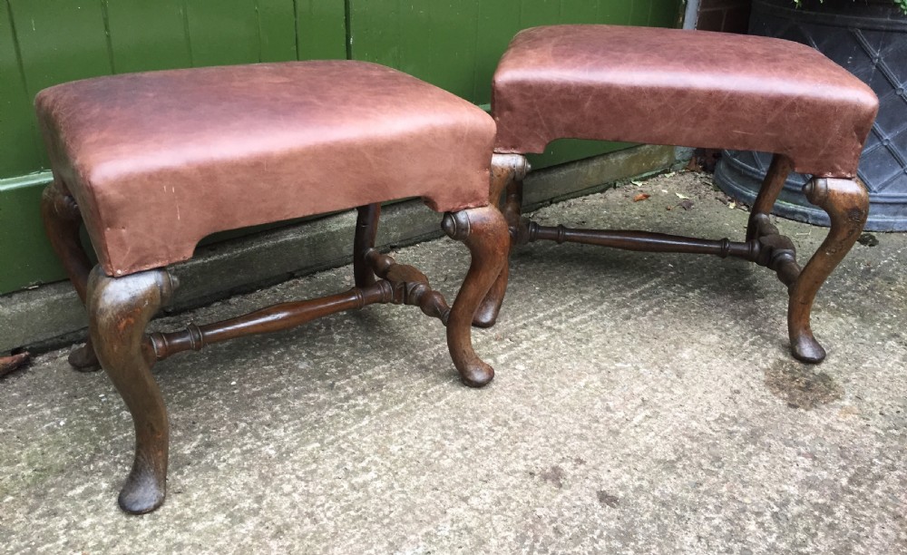 pair of c19th oakframed cabriole legged leather top stools in the early c18th manner