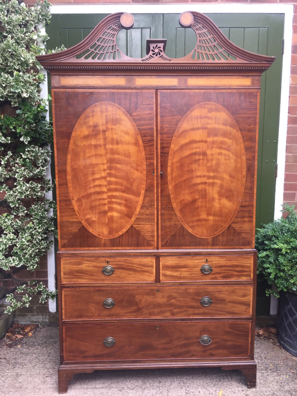 impressive late c18th george iii period mahogany and satinwood linen press or wardrobe with 'swanneck' pediment