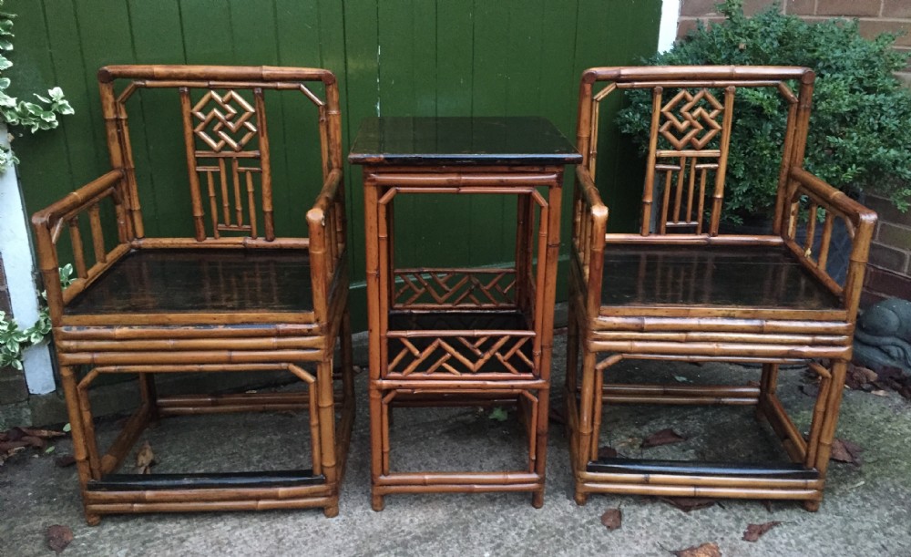 decorative pair of early c20th chinese polished bamboo and lacquer armchairs and table in the c18th manner