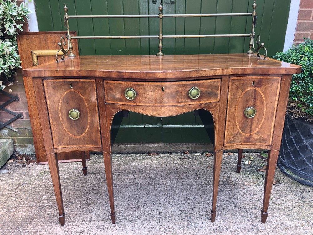 fine late c18th george iii sheraton period mahogany serpentine front sideboard of compact proportions