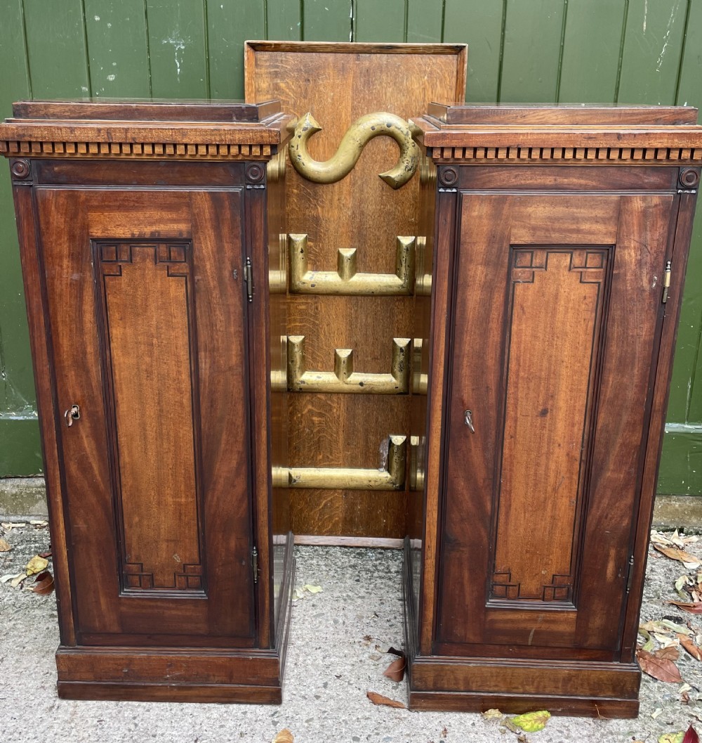 pair of early c19th mahogany pedestal cabinets of classical architecturallyinspired design