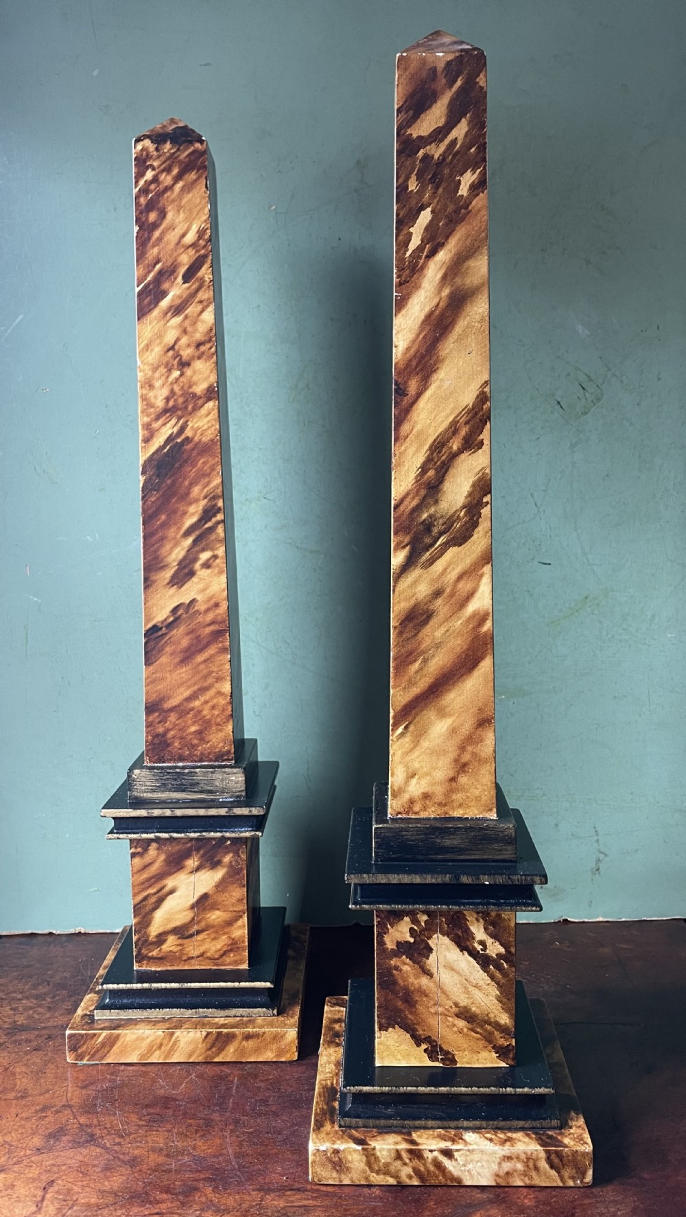 highly decorative tall pair of wooden mid c20th faux tortoiseshell painted obelisks
