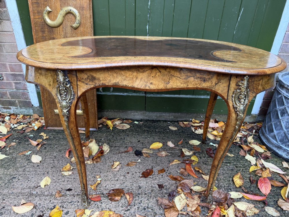 fine quality mid c19th ormolumounted burr and figured walnut kidneyshaped writing table or bureauplat