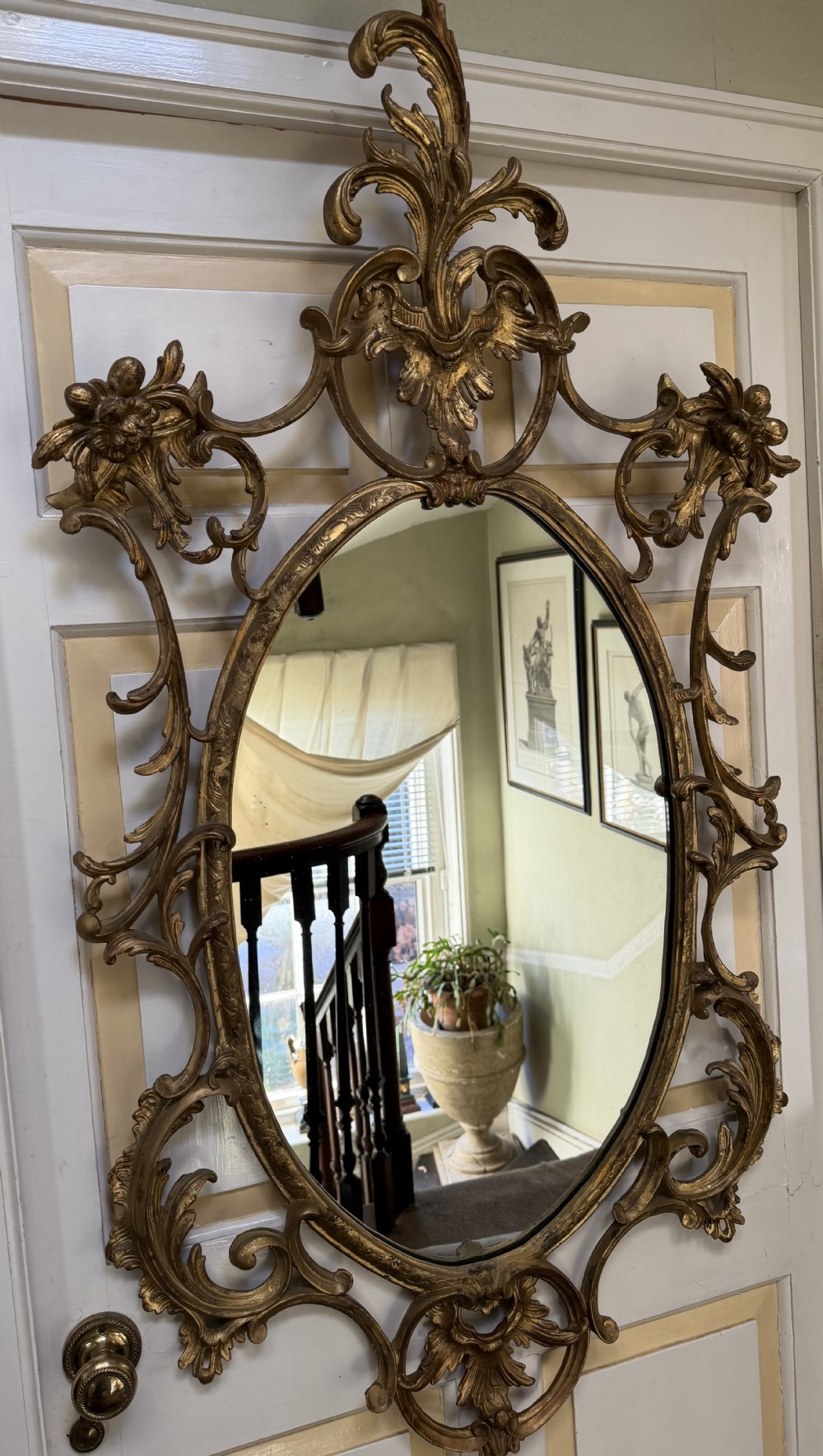 flamboyant early c20th carved giltwood and composition rococostyle framed oval mirror of c18th period design in the manner of thomas chippendale