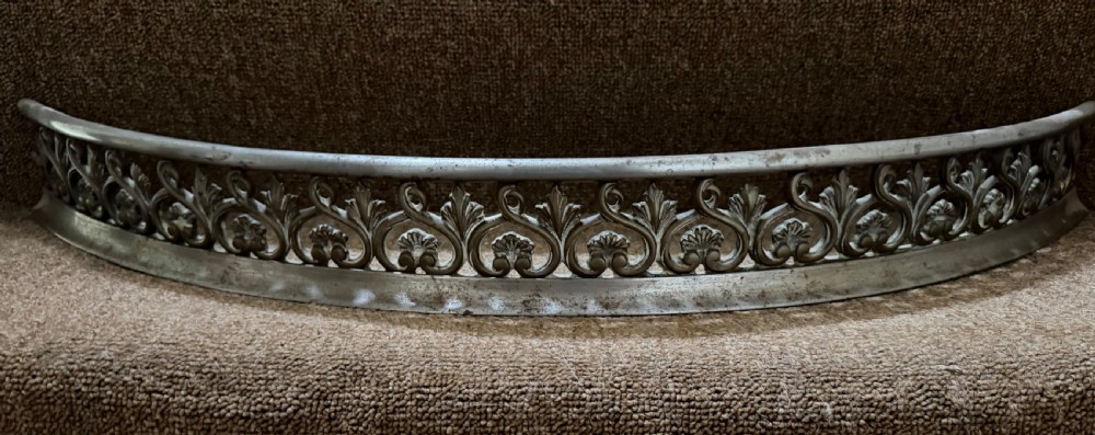 a small scale early c19th steel fireplace curb with finely cast classical style decoration