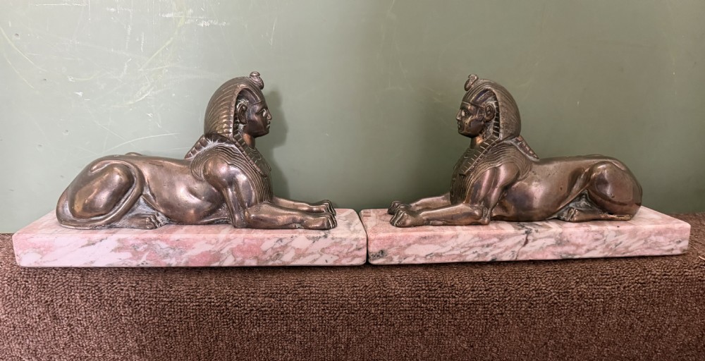 larger scale pair of early c19th regency period bronze sculptures of recumbent sphinxes on marble block plinth bases
