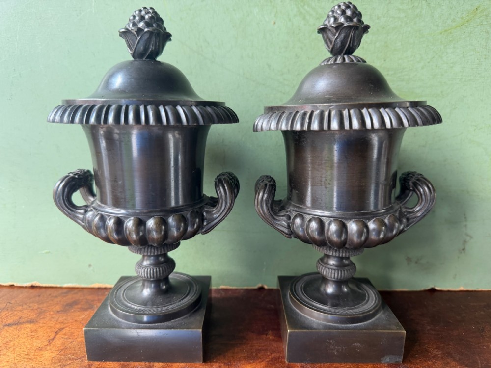 pair of early c19th regency period bronze campanashaped reversible candlestick cassolettes and pastille burners of classical urn design